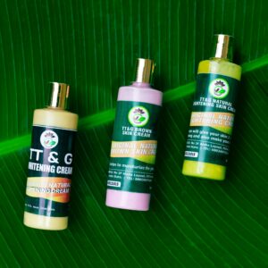 Three colorful skincare bottles displayed on a lush green leaf, promoting natural beauty products.
